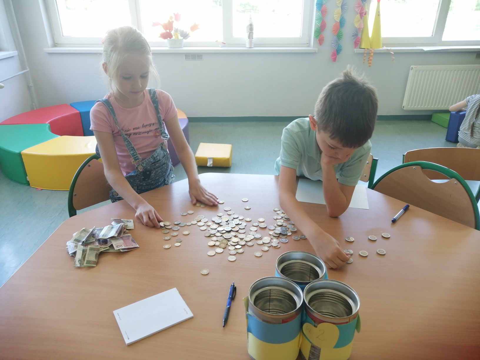 Uczniowie liczący pieniądze z akcji 
